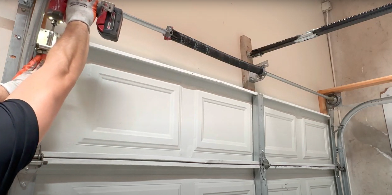 Technician performing a garage door section replacement on a residential garage in Dublin, ensuring smooth operation and durability."