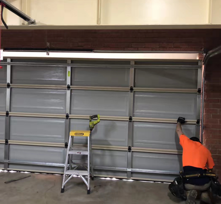 Technician repairing a residential garage door in Dublin, showcasing professional local garage door repair services.