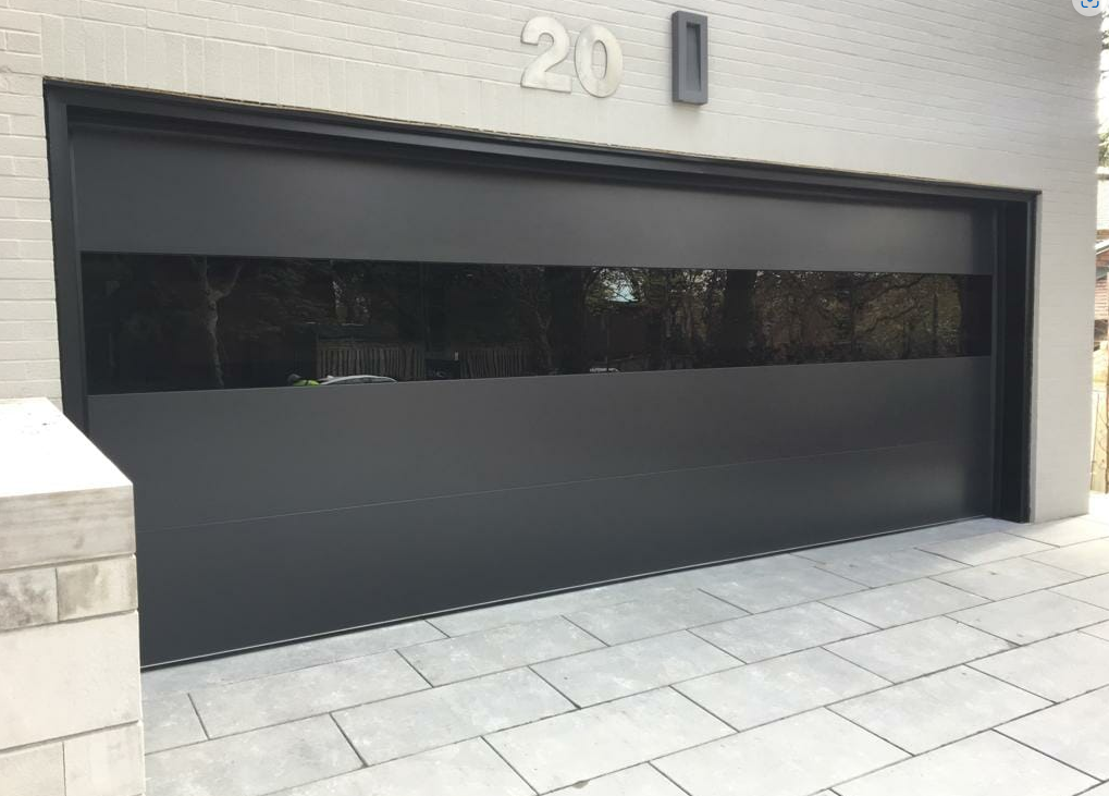 Technician performing a garage door panel repair on a white garage door in Dublin, ensuring proper alignment and functionality.