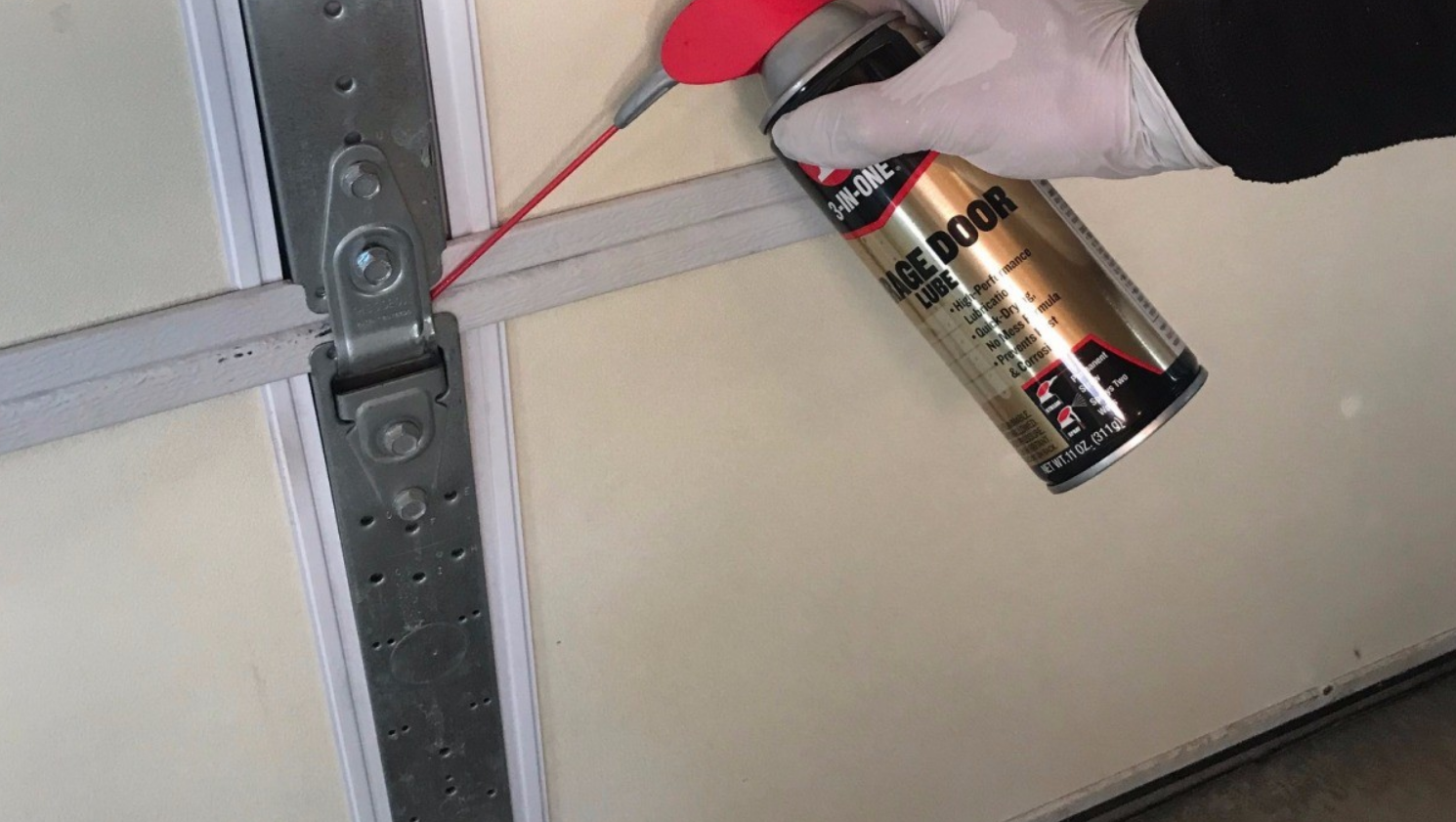 Technician repairing a noisy garage door in Dublin using professional tools, highlighting expert solutions for garage door noise issues.