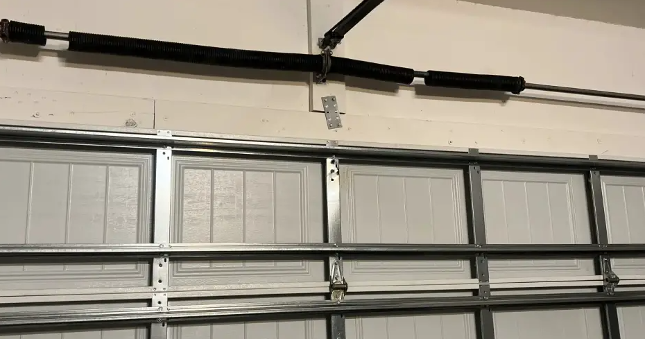 Professional technician diagnosing a residential overhead garage door tracking system structure in Circleville